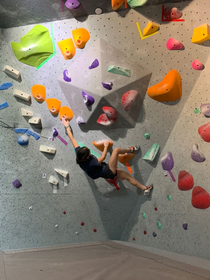 a man climbing up the side of a rock wall