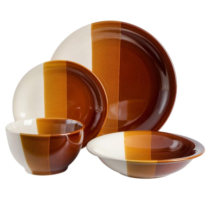 an orange and white striped dinnerware set on a white background with two bowls, one plate