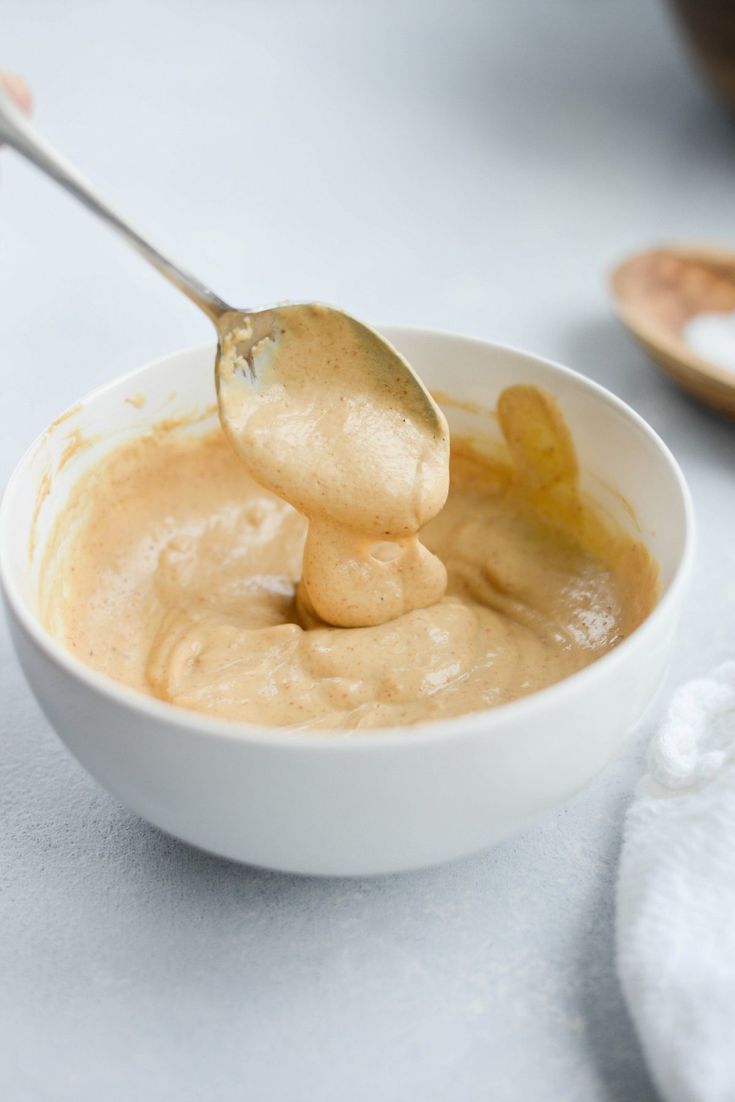 a spoon with some food in it on a table