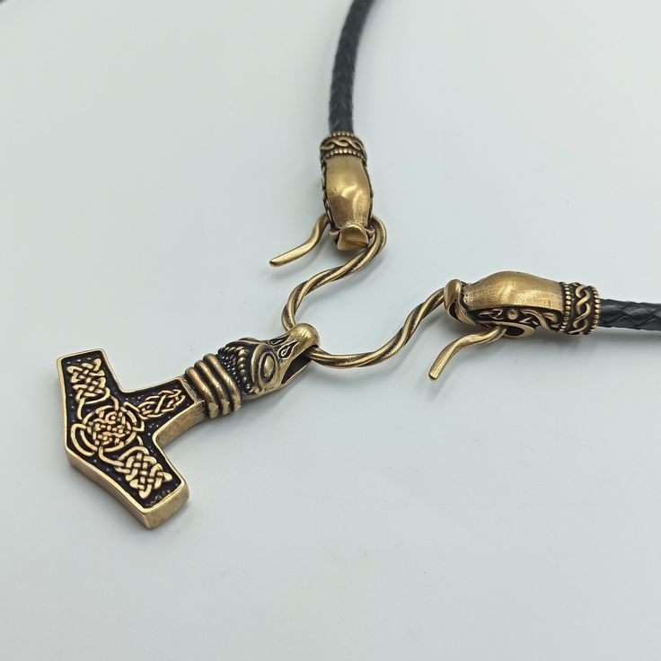 This Mjolnir pendant is reenactment of archeological find based on artifacts from 10th century Denmark. The Hammer of Thor is made from Italian bronze, this is high quality replica. The necklace is made from leather cord. The Thors Hammer in Viking age was used as amulet for men and women. If you like Norse or Nordic jewelry - you`ll like this item. The item shipped in wooden jewelty box, so it`s perfect mens gifts option. The are wolf, raven, dragon, goat, bear necklace variations. Thors hammer Ancient Norse Jewelry, Norse Jewelry Norse Spirit, Handmade Viking Pendant Necklace, Thor Hammer Pendant, Norse Necklace, Mjolnir Pendant, Archaeological Finds, Viking Runes, Bear Necklace