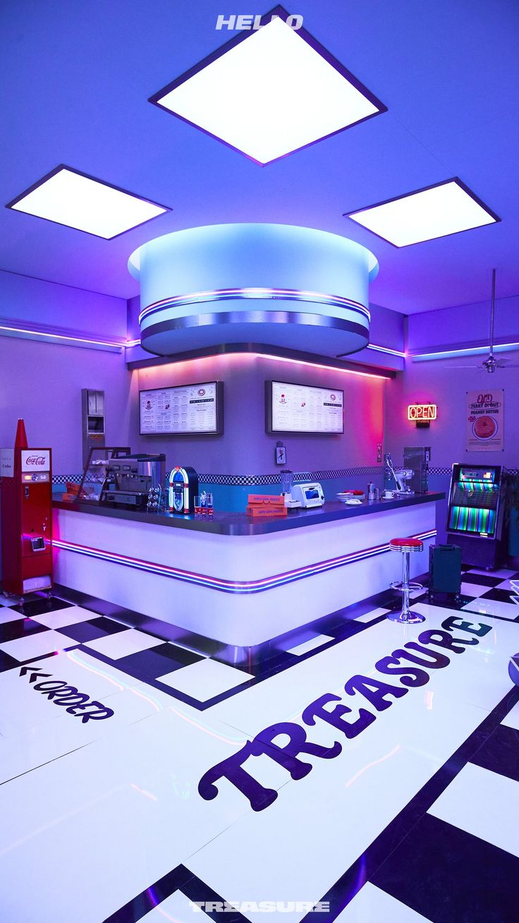 the interior of a restaurant with checkered flooring and neon lights on the ceiling