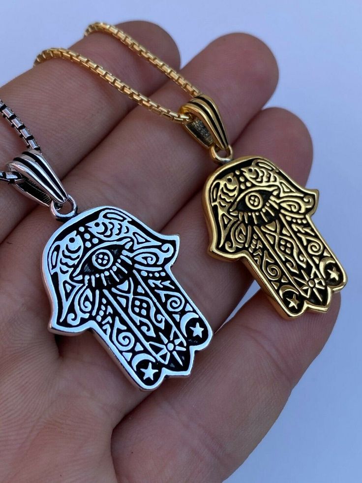 "Beautifully Hand crafted Hamsa pendants **IF YOU WANT A PENDANT ONLY AND NO CHAIN, PLEASE SELECT \"0\" CHAIN LENGTH** Solid 925 sterling silver! Unique custom made one of a kind! We have 2 styles! Rhodium finished & 14k yellow gold finished! Gold is vermeil bonded to solid silver underneath so color wont fade or tarnish Both are oxidized (blackened to give a more vintage look) Pendant measures roughly 1.25\" by 1.25\" (1.75\" w. bale)...weighs roughly 10.5 grams! 100% 925 silver...not plate Silver 14k Gold Charm Necklace Tarnish Resistant, Symbolic Sterling Silver Engraved Charm Necklaces, Symbolic White Gold Stainless Steel Jewelry, Polished Metal Jewelry Gift, Good Luck Sterling Silver Tarnish-resistant Jewelry, Symbolic Stainless Steel Jewelry With Polished Finish, Spiritual White Gold Jewelry Tarnish Resistant, Tarnish-resistant Sterling Silver Good Luck Jewelry, Symbolic Engraved White Gold Jewelry