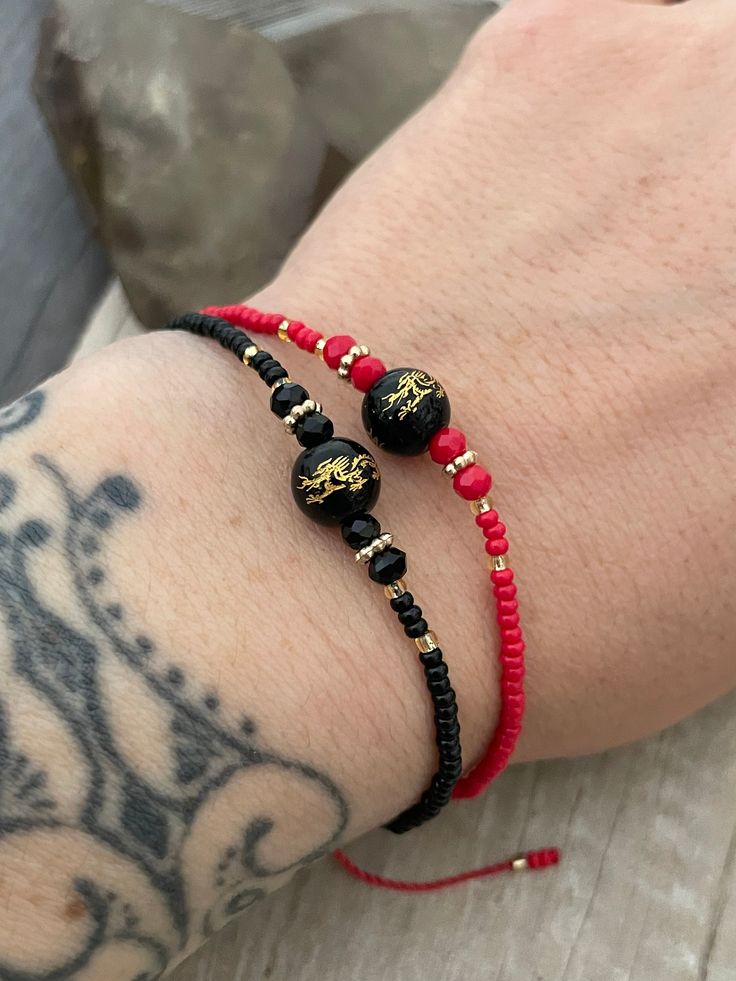 Dainty beaded Chinese Dragon bracelets, they are size adjustable and are available in black and red as shown in the pictures. This could be perfect matching or friendship bracelets, but also a unique layering bracelet to add to your collection. A most have addition to your everyday bracelets. ⚡️GET 20% OFF NOW⚡️ JOIN AKASHI'S VIP LIST and Shop ⚡️Join Akashi's VIP list for early bird discount access⚡️ Paste into your browser http://eepurl.com/hgCMM1 and follow the simple steps. ⚡️To see more unique jewelry, click the link below👇 https://www.etsy.com/shop/AkashiJewelry?ref=seller-platform-mcnav Enjoy Con salud Black Round Beads Friendship Bracelets With Adjustable Length, Black Friendship Bracelets With Adjustable Round Beads, Adjustable Black Beaded Friendship Bracelets, Black Adjustable Length Round Beads Friendship Bracelets, Adjustable Black Hand-strung Friendship Bracelets, Adjustable Black Beaded Bracelets For Festival, Black Beaded Bracelet With Tiny Beads As Gift, Adjustable Black Beads For Gifts, Black Tiny Beads Bracelets For Friendship