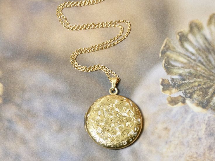 This gold circle locket necklace is a great keepsake necklace. It opens for your favorite two photographs. You will need to find a photo that fits and glue it into place. We do not place the photo in for you and at this time we do not engrave. Its the perfect gift for all agesI T E M • DETAIL:- PENDANT SIZE: Outside measurements 1" round, Inside measurement 3/4" round- CHAIN LENGTH: 16" Delicate Gold Link ChainC A R E • T I P S:We don’t want your special moment to fade. To maintain the quality o Elegant Round Pendant Locket Necklace With Birth Flower, Elegant Round Locket Necklace With Birth Flower, Elegant Birth Flower Round Pendant Locket Necklace, Round Pendant Locket Necklace With Birth Flower For Anniversary, Medallion Locket Necklace With Birth Flower For Keepsake, Birth Flower Locket Necklace Keepsake, Keepsake Medallion Locket Necklace With Birth Flower, Anniversary Round Pendant Locket Necklace With Birth Flower, Anniversary Locket Necklace With Birth Flower