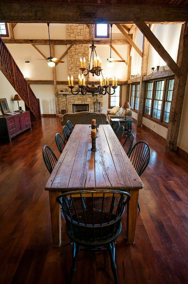 a large wooden table sitting in the middle of a room with lots of chairs around it