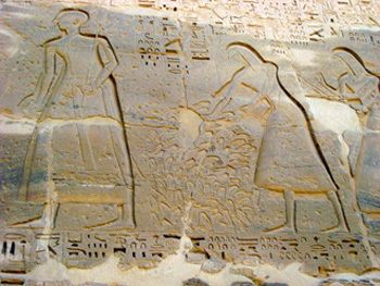 an image of ancient egyptian carvings on the side of a stone wall with writing and symbols