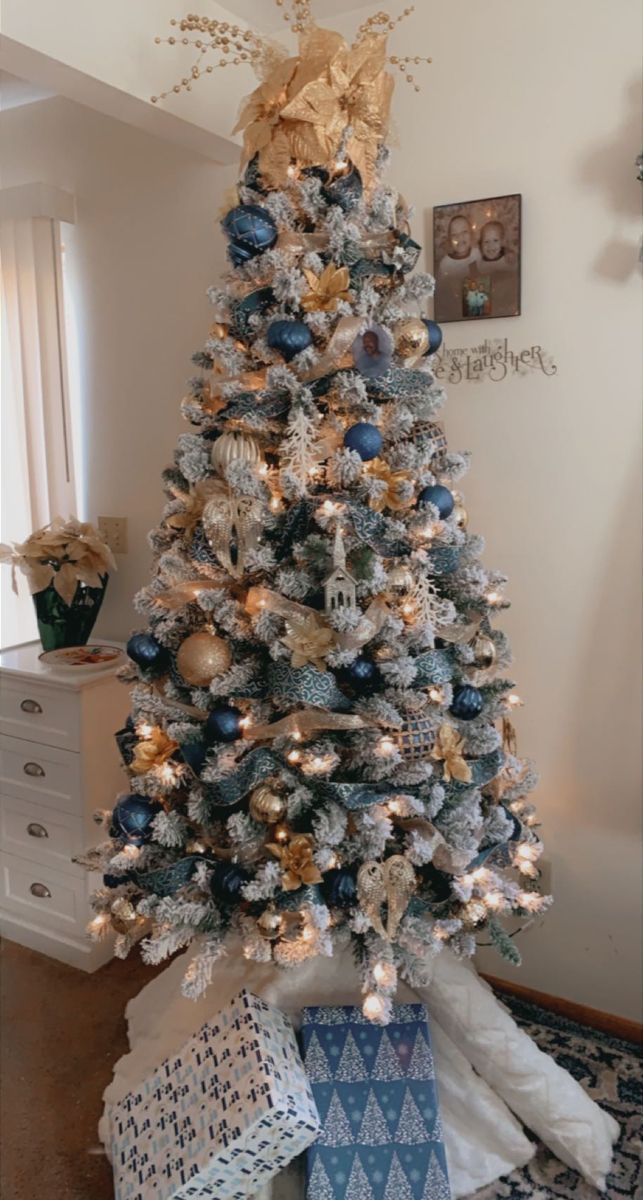 a decorated christmas tree with blue and gold ornaments