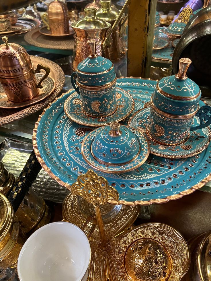 a table topped with blue and gold dishes