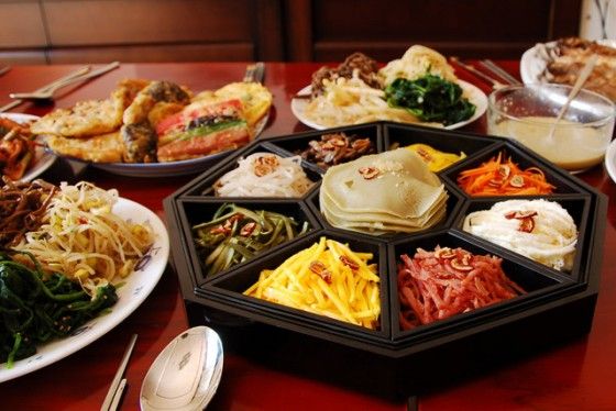 a table topped with plates filled with different types of food next to utensils