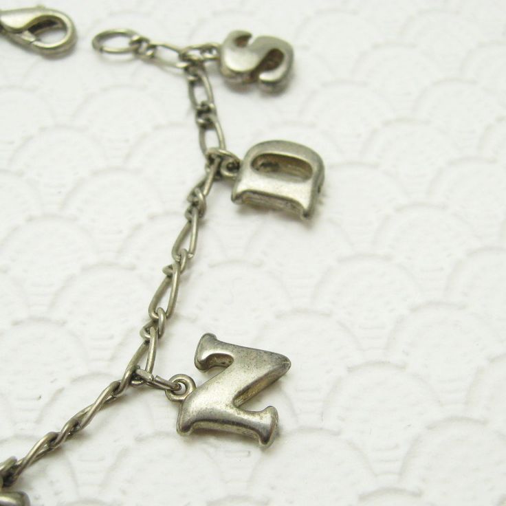 Vintage charm bracelet in silver tone with lobster clasp on a figaro chain bracelet. Slightly puffy two sided letter charms spell the word friends. A sweet vintage bracelet and mom would love from her daughter. Unsigned, in very good condition, 7 1/8 inch long. Find lots more vintage jewelry at Purple Daisy Jewelry! http://www.etsy.com/shop/purpledaisyjewelry Thanks a bunch for shopping for vintage jewelry at Purple Daisy Jewelry on Etsy! Vintage Personalized Dangle Jewelry, Personalized Vintage Dangle Jewelry, Silver Nickel-free Name Bracelet For Friendship, Vintage Adjustable Charm Bracelet For Everyday, Metal Charm Bracelet For Birthday And Mother's Day, Antique Silver Nickel-free Charm Bracelet For Gift, Metal Charm Bracelets For Birthday, Antique Silver Charm Bracelet As Gift, Antique Silver Metal Charm Bracelet Gift