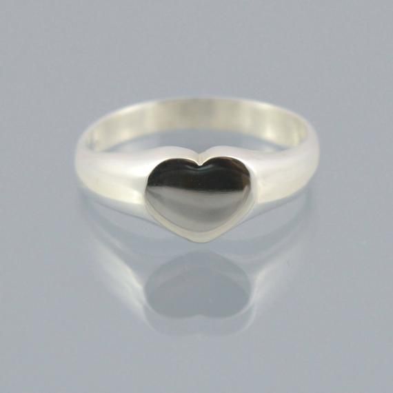 Handmade in 925 sterling silver this beautiful ring is made to order to your finger sizeThe Heart shaped top top is approx 9mm across the finger by 7mm along the finger. We can use all international ring size scales,  PLEASE LEAVE A NOTE OF YOUR FINGER SIZE AT CHECKOUT.All our items are delivered in a presentation box and all packaging is included in the shipping. All items are sent using the French La Poste system by Priority Letter. If you require tracking an upgrade is available at checkout.T Sterling Silver Ring With Shiny Finish, Handmade Sterling Silver Promise Signet Ring, Handmade Sterling Silver Signet Ring For Promise, Silver Heart Ring With Polished Finish Gift, Dainty Sterling Silver Signet Ring For Wedding, Silver Minimalist Signet Ring For Promise, Silver Heart Ring With Polished Finish, Minimalist Silver Signet Ring For Promise, Sterling Silver Signet Ring With Polished Finish As Gift