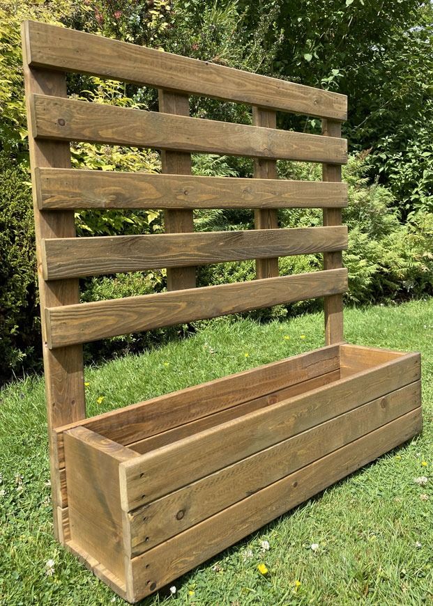 a wooden bench sitting on top of a lush green field