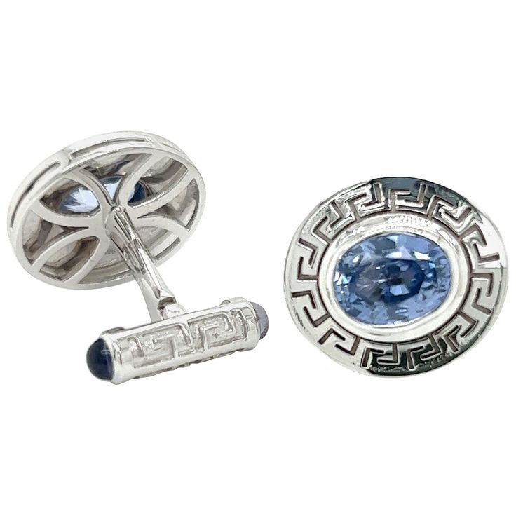 Elevate your formal attire to new heights with these exquisite 18k White Gold Cufflinks, featuring a breathtaking total of 6.83 carats of Oval Cornflower Blue Sapphires on the front and Cabochon Iolites adorning the swivel backings. These cufflinks are a true masterpiece, meticulously crafted to harmonize the allure of precious gemstones with the timeless elegance of Greek key detailing, resulting in an opulent and distinguished accessory. Captivating Cornflower Blue Sapphires: The front of each Gold Cufflinks, Black Tie Event, Ancient Symbols, Key Design, Greek Key, Blue Skies, Formal Attire, Cornflower Blue, Precious Gemstones