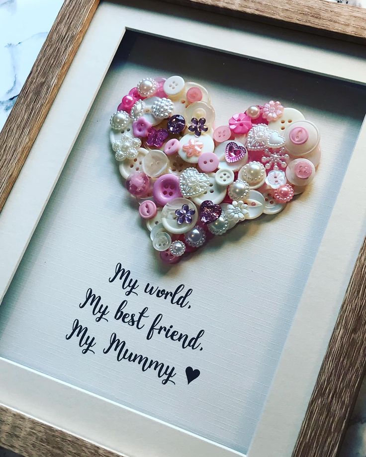 a frame with buttons in the shape of a heart that says my world, my best friend, my mommy