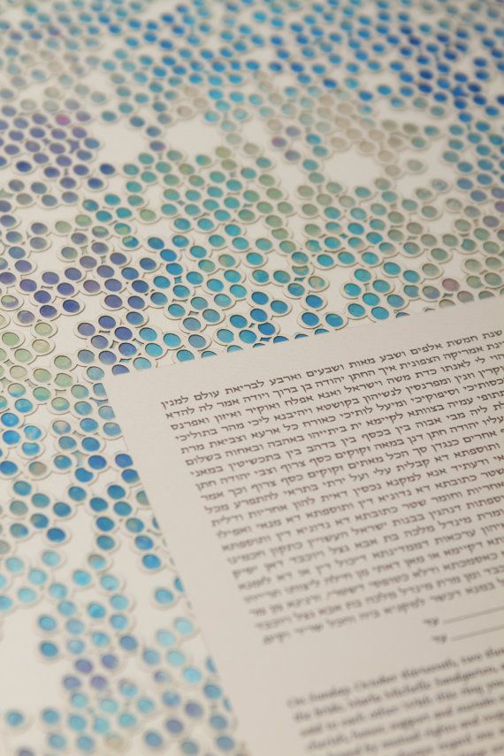 an open book with blue and green dots on it