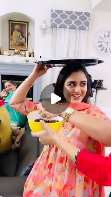 two women are serving themselves food in the living room