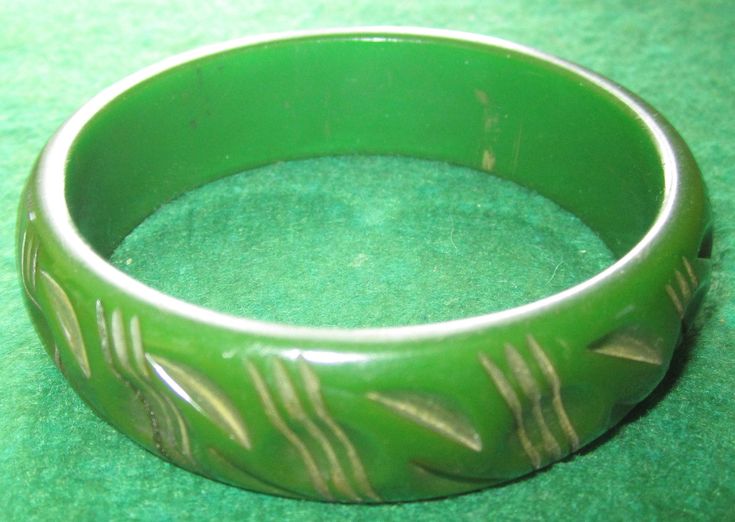 "A Vintage 1940's Carved Green Bakelite Bangle Bracelet. Visit this shop for a wide variety of Vintage Quality Jewelry, Art, Photos and Collectibles. ~Age (approximate): 1940's ~Material(s): Bakelite ~Approx. Size: 2 1/2\" across ~Approx. Weight: N/A ~Signature / Brand: Unsigned. ~Condition: Very Good +. ~International Shipping: Is Available, please contact us for a quote. ~Inventory #: 3871" Green Vintage Cuff Bracelet, Vintage Green Bangle Jewelry, Vintage Green Cuff Bracelet For Formal Events, Vintage Green Cuff Bracelet For Formal Occasions, Green Vintage Cuff Bracelet For Formal Occasions, Retro Green Bracelet Jewelry, Green Vintage Formal Cuff Bracelet, Retro Green Bangle Bracelets, Antique Green Handmade Bracelet