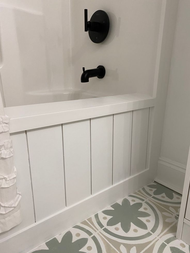 a bathroom with white walls and gray flooring