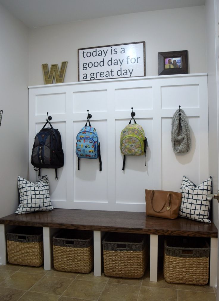 the entryway is decorated with baskets and coat hooks