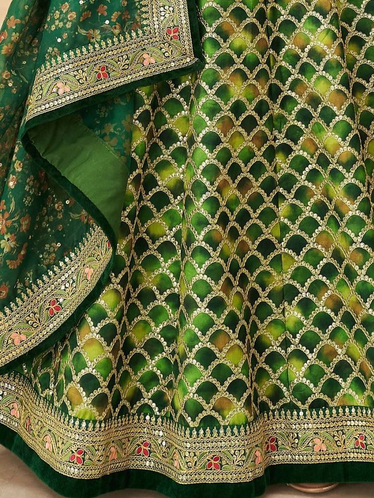 Look stunningly beautiful in this enticing green color lehenga made of art silk material embellished with thread embroidery, sequins work, dori work, and lace border work. This gorgeous green color lehenga comes with a similar color blouse designed with sequins and dori work featured with a similar color organza dupatta with floral printed and lace border work. This lovely green engagement wear lehenga is semi-stitched can fit up to 42 inches and comes with fully unstitched choli material. The l Green Color Lehenga, Sequins Lehenga Choli, Embroidery Thread Work, Sequin Lehenga, Dori Work, Designer Embroidery, Green Lehenga, Perfect Bridesmaid Dress, Indian Look