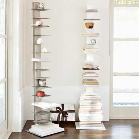 a stack of books sitting on top of a hard wood floor next to a window