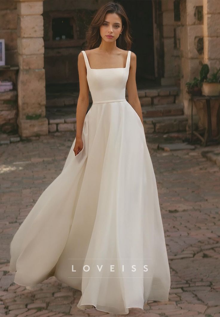 a woman in a white dress is standing on a brick floor with her hands behind her back