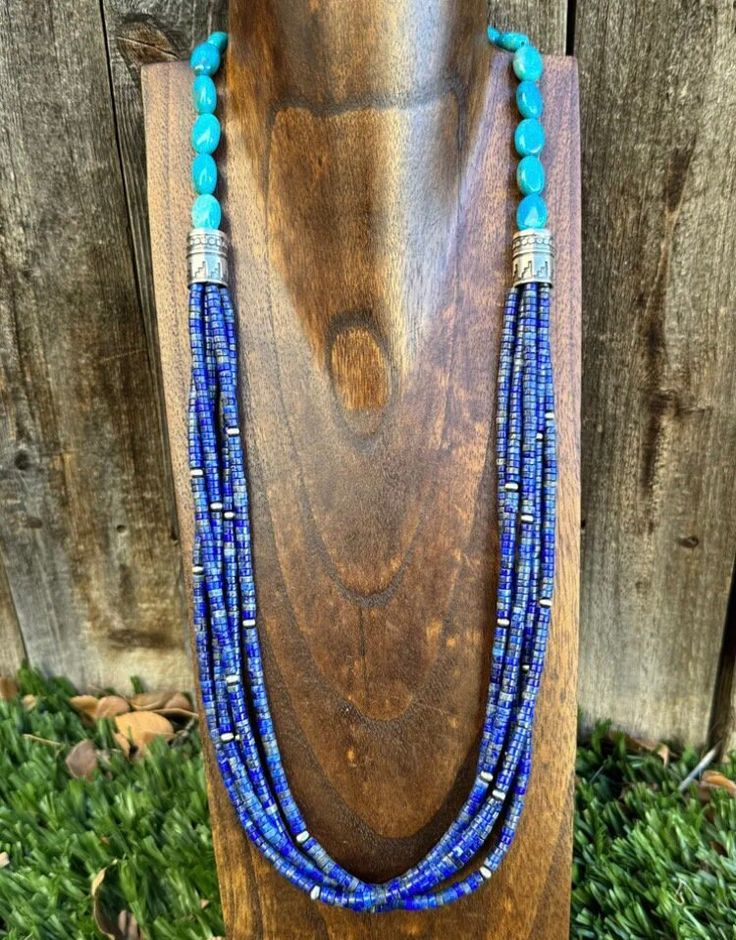 Add a touch of Southwestern flavor to your jewelry collection with this beautiful beaded necklace. Made of .925 sterling silver, this 28-inch necklace features multiple strands of stunning lapis and turquoise beads. The intricate beading and vibrant blue colors make this piece a true statement accessory. Perfect for any occasion, this necklace is a must-have for any jewelry lover. Its unique design and high-quality materials ensure that it will be a cherished piece in your collection for years to come. Don't miss out on the chance to add this beautiful beaded necklace to your wardrobe today! Artisan Blue Jewelry With Colorful Beads, Blue Artisan Jewelry With Colorful Beads, Sterling Silver Beaded Multi-strand Jewelry, Bohemian Lapis Lazuli Jewelry With Colorful Beads, Southwestern Multi-strand Beads For Gift, Southwestern Double Strand Beaded Jewelry, Southwestern Multi-strand Jewelry With Colorful Beads, Southwestern Multi-strand Colorful Beads Jewelry, Multi-strand Turquoise Gemstone Beads Necklace