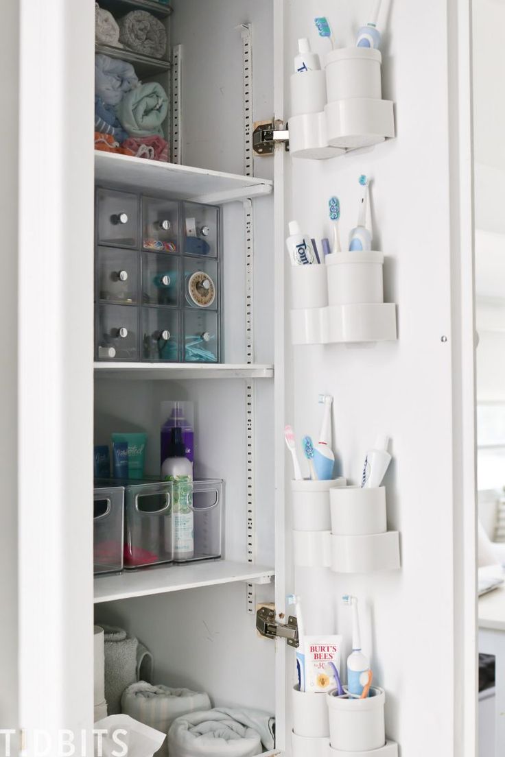 the inside of a white refrigerator filled with lots of toilet paper and toothbrushes