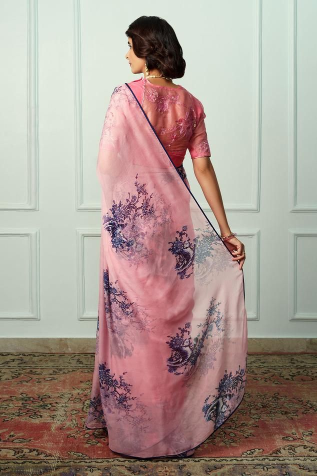 Pink french chiffon saree with floral print and satin piping. Comes with an organza embroidered unstitched blouse piece.
Components: 2
Pattern: Printed, Embroidered
Type Of Work: Floral
Fabric: Saree : French chiffon, Blouse Piece : Organza
Color: Pink
Other Details: 
Length :
Saree : 5.5 mtrs
Unstitched Blouse : 1 mtr
Note : Stitched blouse worn by the model is not for sale.
Occasion: Wedding - Aza Fashions Floral Print Saree, Floral Print Sarees, Pink French, Chiffon Saree, Printed Sarees, Chiffon Blouse, Blouse Piece, Floral Fabric, Aza Fashion