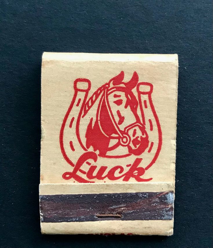 a rubber stamp with a horse on it's head and the word luck in red ink