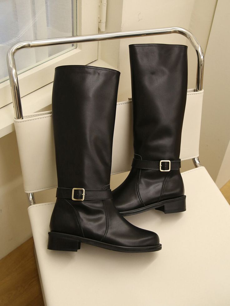 Editor's NotesHailey presents long boots that feature buckle strap accents around the ankle. They are timeless fashion pieces that can be worn comfortably for extended periods of time with the low-heel design. - Long boots with buckle straps- Smooth plain leather- Comfortable low heels- Zipper closure- Gold-tone hardware- Classic and casual mood Measurements(in.)- Size: KR 225MM (US 5.5) ~ KR 255MM (US 8.5)- Heel: 1.18 in. Composition & Care- Material: Cow Leather- Natura Fall Knee-high Boots With Buckle Closure, Elegant Moto Boots With Buckle Closure For Winter, Elegant Winter Moto Boots With Buckle Closure, Elegant Knee-high Moto Boots For Workwear, Elegant Moto Boots With Buckle For Work, Elegant Knee-high Moto Boots For Work, Elegant Moto Boots With Buckle Closure For Work, Knee-high Moto Boots With Buckle Closure For Work, Workwear Knee-high Boots With Buckle Closure