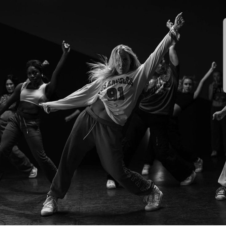 a group of young women dancing in a dance studio