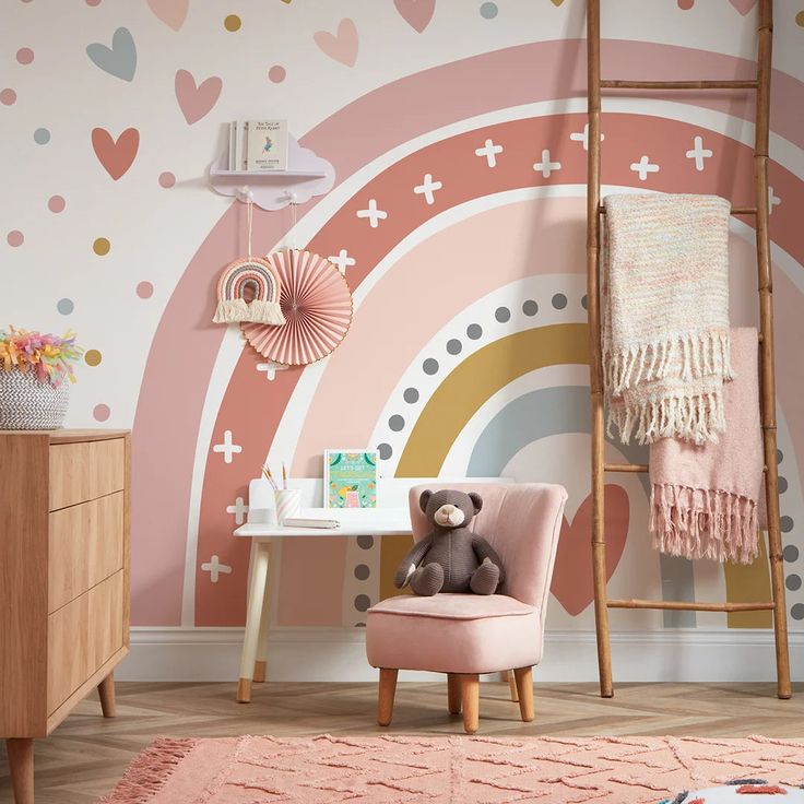 a child's room decorated in pastel colors with hearts and rainbows on the wall