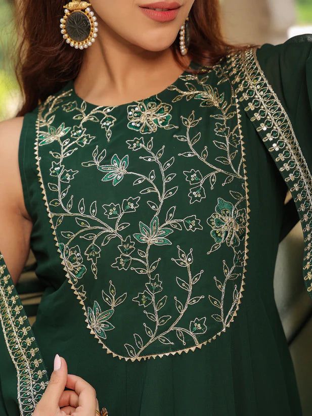 Grab this beautiful 2-piece set. The set comes with embroidered anarkali kurta has round neck, sleeveless & ankle length teamed with a flared cape 2 Piece Set Color - Dark Green Kurta Fabric-Georgette Kurta Length - 55 inches Cape Length - 36 inches Neck-Round Neck Kurta Sleeves-Sleeveless Cape Sleeves - Short Flared Work -Embroidery Detailing DISCLAIMER - The color of the product may be differ due to screen settings of device. A misprint here and a color drop slip there is the beauty of printin Georgette Dress With Cape Sleeves For Navratri, Festive Embroidered Palazzo Set With Cape Sleeves, Traditional Embroidered Anarkali Set With Cape Sleeves, Bollywood Embroidered Palazzo Set With Cape Sleeves, Eid Georgette Kurta With Cape Sleeves, Eid Festival Georgette Kurta With Cape Sleeves, Eid Kurta With Cape Sleeves In Georgette, Anarkali Palazzo Set With Cape Sleeves For Festivals, Designer Dresses With Intricate Embroidery And Cape Sleeves