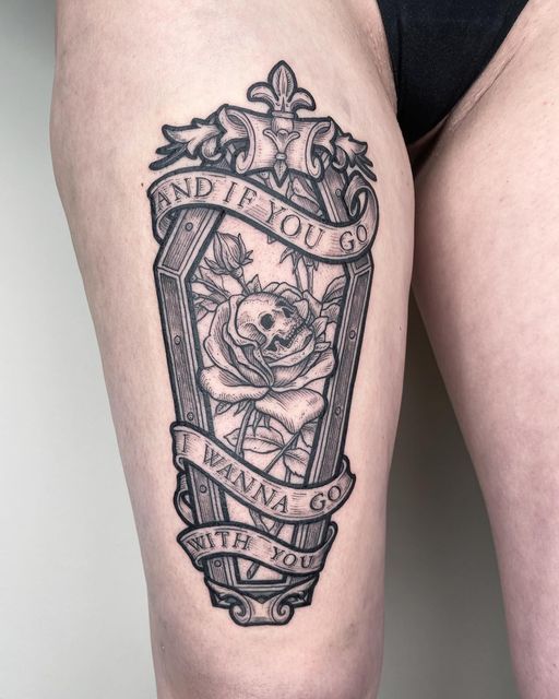 a woman's thigh with a tattoo on it