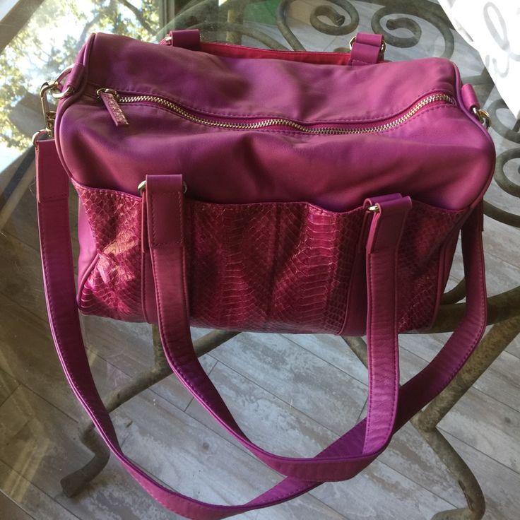 Very Soft Magenta Leather Satchel With 10" Long Top Metal Zipper Closure. Each Side Has A 12"W X 7"H Snakeskin Exterior Pocket With Magnetic Closures One Zippered And 2 Open Pockets On Interior. Both Interior And Exterior Pockets Lined In Fuchsia Fabric. Two 24"X 1" Matching Leather Handles With 10" Handle Drop. Detachable 30"X1" Matching Magenta Leather Cross-Body Strap. Silver Hardware. Nwot. Dust Bag Included. Leather Cross, Leather Handles, Metal Zipper, 6 D, Leather Purse, Leather Satchel, 7 H, Silver Hardware, Leather Handle