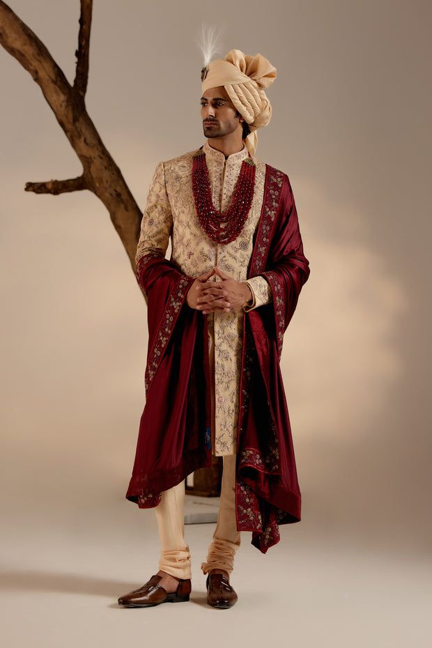 Pale Gold Sherwani | Jatin Malik Introducing our exquisite golden heavy hand-embroidered sherwani set, a true work of art. This sherwani features an intricate embroidery technique combining zardosi and aari work, showcasing unparalleled craftsmanship and attention to detail. Perfect for those seeking to make a grand and sophisticated statement, this sherwani set epitomizes luxury and traditional elegance. Included in purchase: Sherwani, Kurta, Churidar Product Specification Color: Golden Fabric: Linen silk Occasion: Engagement, Wedding, Bridal, Reception Style: Sherwani, Kurta, Churidar Care: Dry Clean Work: Hand Embroidery Customization options:Can be customized in any color or style Note: A stylist will contact you to confirm measurements after your order is placed.Estimated delivery tim Semi-stitched Gold Kurta With Naqshi, Festive Gold Anarkali Set With Naqshi, Traditional Naqshi Drape In Raw Silk, Festive Gold Anarkali Set With Naqshi Detail, Designer Gold Sets With Naqshi Detailing, Festive Raw Silk Sherwani With Dabka Work, Gold Sherwani With Zari Work For Designer Wear, Traditional Raw Silk Wear With Naqshi Detailing, Designer Kundan Sherwani With Dupatta