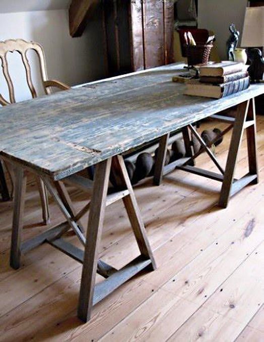 an old table with books on it in a room