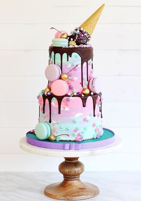 a three tiered cake with chocolate icing and decorations on top is displayed in an instagram