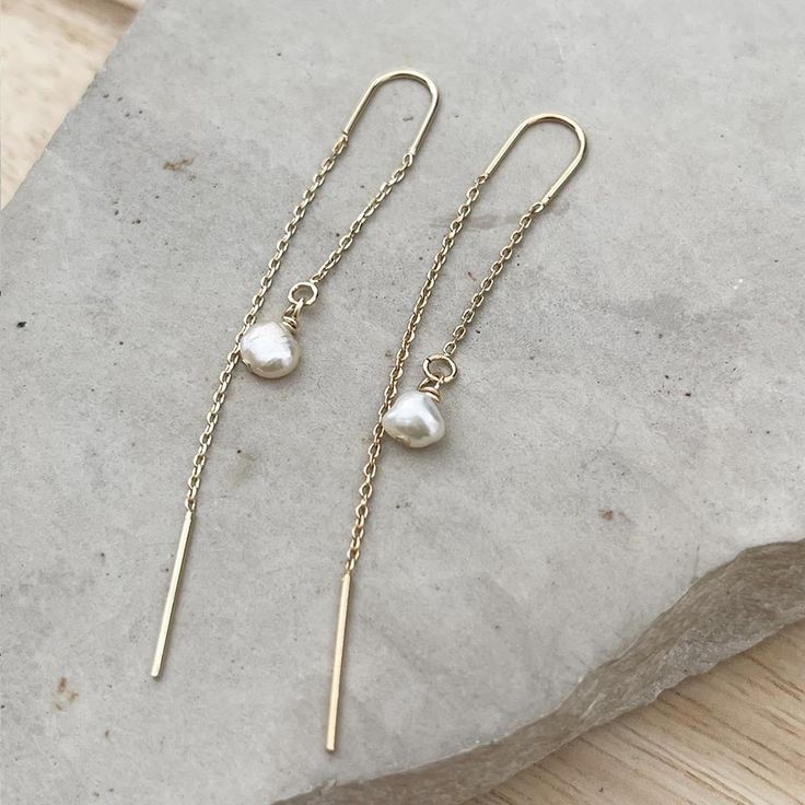 Minimalist Pearl Ear threader earrings, these dainty chain earrings with the perfect touch of femininity and it's great to combine with other earrings or wear alone for a minimalist look.Fun and delicate, these 14k gold-filled threader earrings come with wire bar ends on one side to make it easy to thread the chain through any pierced hole in your ear and on the other side, a small freshwater pearl. Mix and match with other HLcollection earrings for an edgy style statement or wear it on its own Dainty Adjustable Threader Earrings, Dainty Adjustable Threader Earrings With Pearl Drop, Delicate 14k Gold Filled Threader Earrings, Delicate 14k Gold-filled Threader Earrings, 14k Gold Filled Long Drop Linear Earrings, Dainty Sterling Silver Linear Earrings With Adjustable Chain, Dainty Threader Earrings With Pearl Drop Gift, Hypoallergenic Yellow Gold Threader Drop Earrings, Hypoallergenic 14k Gold Filled Threader Earrings