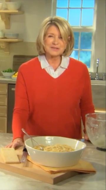 a woman standing in front of a bowl of food