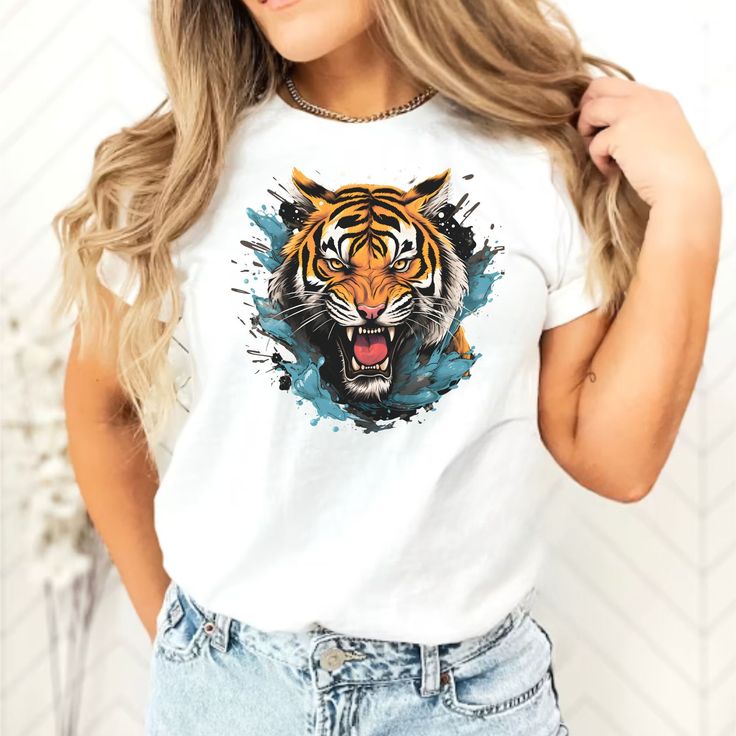 Express your unique style with this vibrant and eye-catching tiger graffiti t-shirt. Featuring a one-of-a-kind watercolor painting of a fierce tiger, this unisex tee is perfect for animal enthusiasts. Made from high-quality materials, it offers both comfort and durability. Stand out from the crowd with this edgy and captivating design that will surely spark conversations. Whether you're looking for a gift or want to add some wild flair to your wardrobe, this t-shirt is a fantastic choice. Embrace the untamed vibes and let your personality shine with this colorful and captivating tiger shirt. 🎨 Vibrant Design: Stand out with the colorful and eye-catching tiger graffiti artwork. ✨ Unique and One-of-a-Kind: Each t-shirt is a unique piece, handcrafted with care and attention to detail. 👕 Uni Short Sleeve Tiger Print T-shirt For Summer, Tiger Print Short Sleeve T-shirt For Summer, Summer Short Sleeve T-shirt With Tiger Print, Cotton Graphic Tee With Tiger Print, Casual Cotton T-shirt With Tiger Print, Casual Summer T-shirt With Tiger Print, Summer Casual Tiger Print T-shirt, Casual Tiger Print T-shirt For Summer, Casual Tiger Print Short Sleeve T-shirt