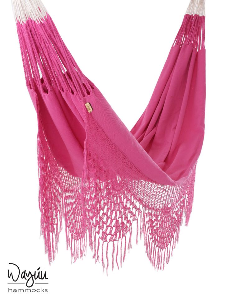 a pink hammock with fringes hanging from it's side on a white background