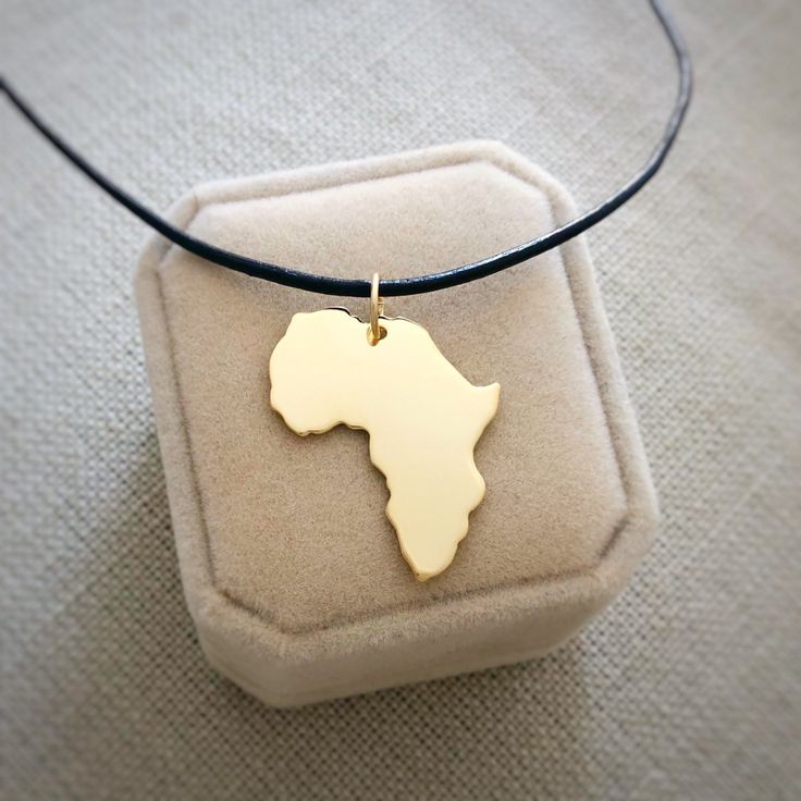 "18kt Gold Plated Africa Necklace, Big size, Golden Heart Africa Ethiopia Pendant Adoption Necklace in a kraft gift box with an Extra Free Gift. ✿Let your heart bring you to places you most love with our jewel maps✿ ✿ JEWEL ✿ PENDANT SIZE: 3x2.5 cm ( 1.2x1 inches). 0.7 mm Thick CHAIN: Now with 18kt gold plated sterling silver chain from 16\" to 18\" aproximately. Please, look the picture. The chain size is exactly 40cm (15 3/4\") and 45cm.m (17 23/32\"). Or 1.5mm leather cord. Ready to ship in 1 Matte Gold Jewelry With Adjustable Chain For Gift, Matte Gold Brass Jewelry As A Gift, Handmade Matte Gold Jewelry Gift, Gold Brass Necklaces For Mother's Day, Mother's Day Gold Brass Necklaces, Mother's Day Gold Brass Necklace, Gold Charm Necklace For Anniversary, Gold Brass Charm Necklace For Gift, Gold Charm Necklace For Anniversary Gift