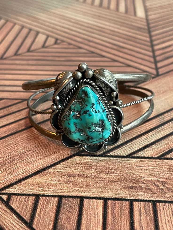 Vintage Sterling Silver & Green Turquoise Navajo Beautiful Cuff Bracelet Layaway Available 6.5" around including gap. Signed sterling. Slightly adjustable. Please see pictures for more measurements Before purchasing, please make sure your shipping address is correct in your Etsy account. I will not change the shipping address after purchase due to so much buyer fraud going around. If you purchase and need an address change, we will have to cancel the transaction and start over.  Return Policy- Buyer must contact me within 5 days of delivery to notify me of return and ship with tracking insured within 7 days of receiving the item. No returns after the allotted days. Buyer pays return shipping and must return item with tracking number. Once item is returned back to me in its original conditi Address Change, American Jewelry, Green Turquoise, Native American Jewelry, Etsy Account, Vintage Sterling Silver, Cuff Bracelet, Tracking Number, Native American