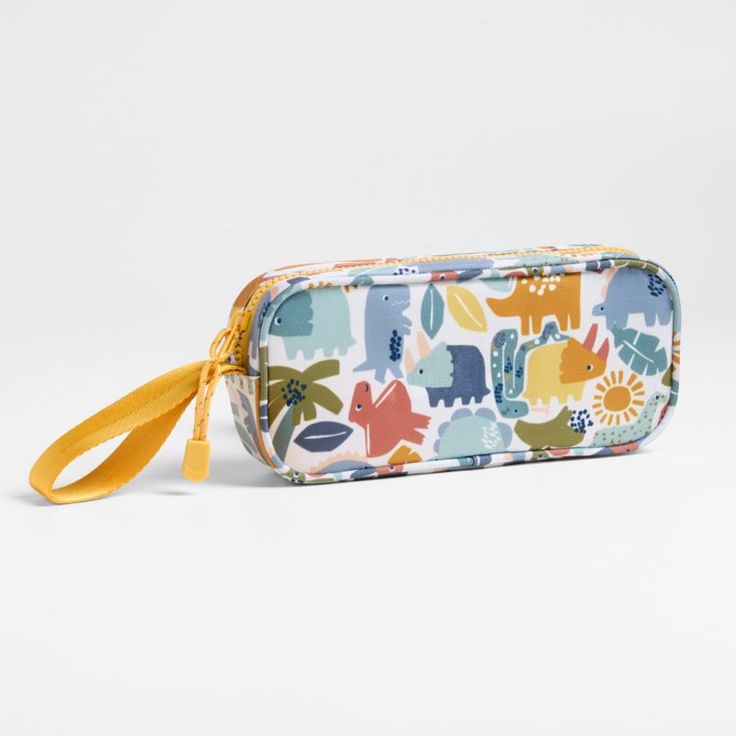 A fun pencil case that's built to handle all the thrills of a day in the wild. Colorful dino pals and a lush landscape decorate the bag's bright white exterior, and a contrasting yellow zipper, zipper pull and loop handle give it the perfect finish. Constructed of supremely durable polyester fabric that includes recycled plastic bottles, our roomy, easy-clean case makes it simple to keep all their pens and pencils organized and accessible. Pair with the Dinosaur Friends lunch box and matching ba Kids Pencil Case, Lush Landscape, Pencil Organizer, Backpack Gift, White Exterior, Kids Gear, Old Fashioned Glass, Pens And Pencils, Kids Lunchbox