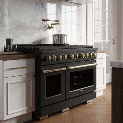 a kitchen with an oven, stove and counter top in white cabinetry next to a window