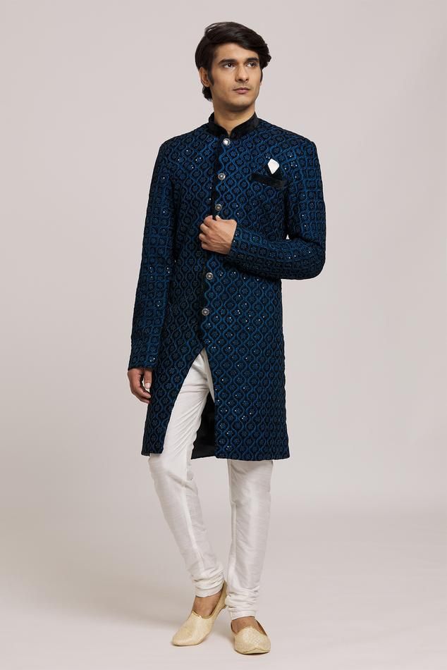 Blue sherwani with embroidered floral jaali patterns embellished with sequins. Comes with churidar.
Components: 2
Pattern: Embroidered
Type Of Work: Floral
Neckline: Mandarin Collar
Sleeve Type: Full
Fabric: Sherwani: Neel Velvet, Churidar: Silk Dupion
Color: Blue
Other Details: 
Embellished buttons
Closure:
Sherwani: Front button
Churidar: Drawstring
Note: Pocket square worn by the model is not for sale
Occasion: Sangeet,Mehendi and Puja - Aza Fashions Eid Reception Traditional Wear With Sequins, Traditional Formal Salwar Kameez With Sequins, Bollywood Style Semi-stitched Sherwani With Mirror Work, Formal Bollywood Kurta With Sequins, Formal Bollywood-style Kurta With Sequins, Traditional Formal Kurta With Sequins, Traditional Sequined Kurta For Formal Occasions, Designer Traditional Wear With Dupatta For Party, Designer Festive Bandhgala With Mirror Work