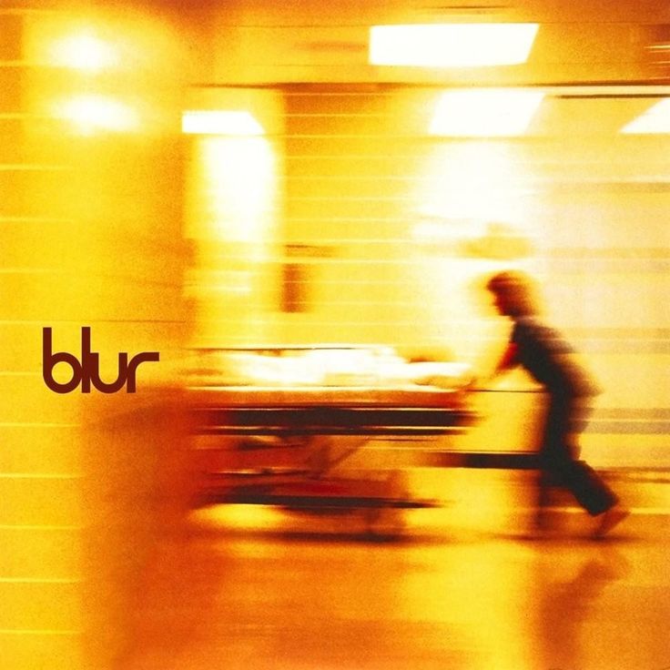 blurry photograph of a man pushing a gurney in an emergency room with the word bur on it