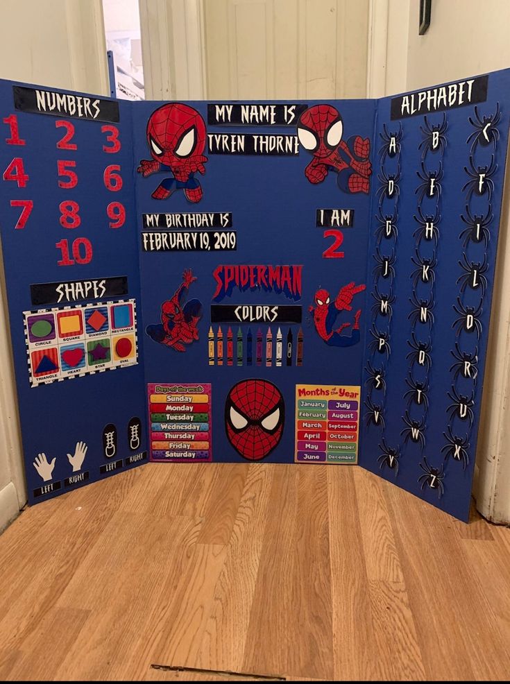 a spiderman themed classroom display in the corner of a room with wooden flooring